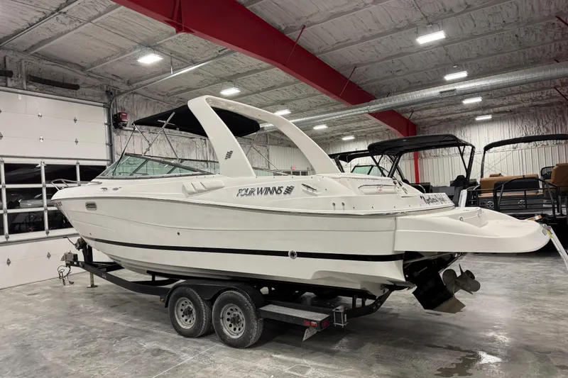 Slide: The Image of 2005 Four Winns 285 Sundowner boat on trailer in indoor storage facility. - 3