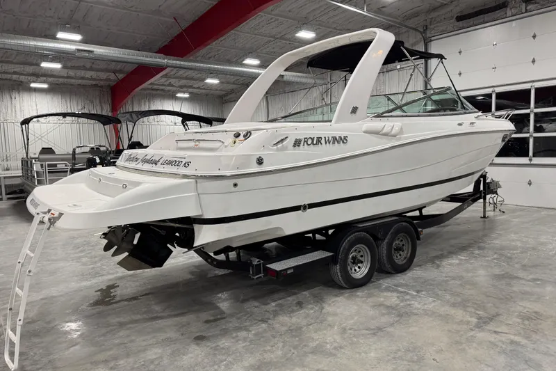 Slide: The Image of 2005 Four Winns 285 Sundowner boat on trailer in indoor storage facility. - 4
