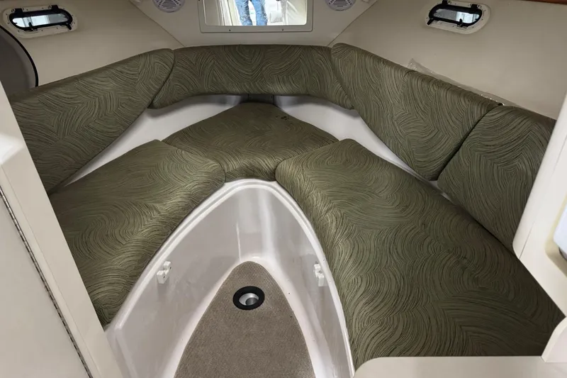 Slide: The Image of 2005 Four Winns 285 Sundowner cabin interior with green patterned seating. - 6
