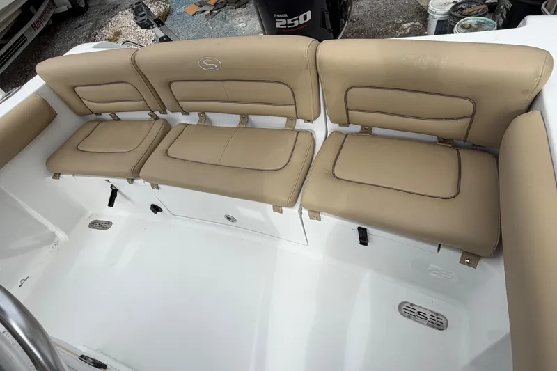Slide: The Image of 2016 Sportsman Heritage 231 Center Console boat with beige cushioned seating. - 10