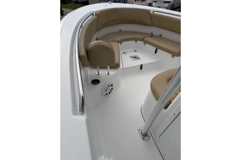 Slide: The Image of 2016 Sportsman Heritage 231 Center Console boat interior with beige seating. - 11