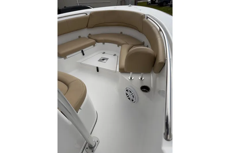 Slide: The Image of 2016 Sportsman Heritage 231 Center Console boat interior with tan seating and white deck. - 12