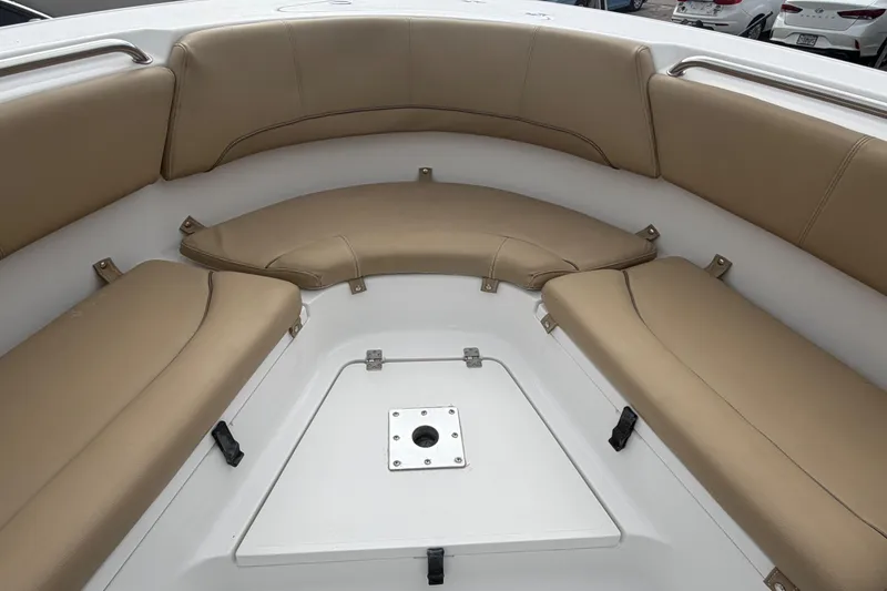 Slide: The Image of 2016 Sportsman Heritage 231 Center Console boat interior with tan cushioned seating. - 13