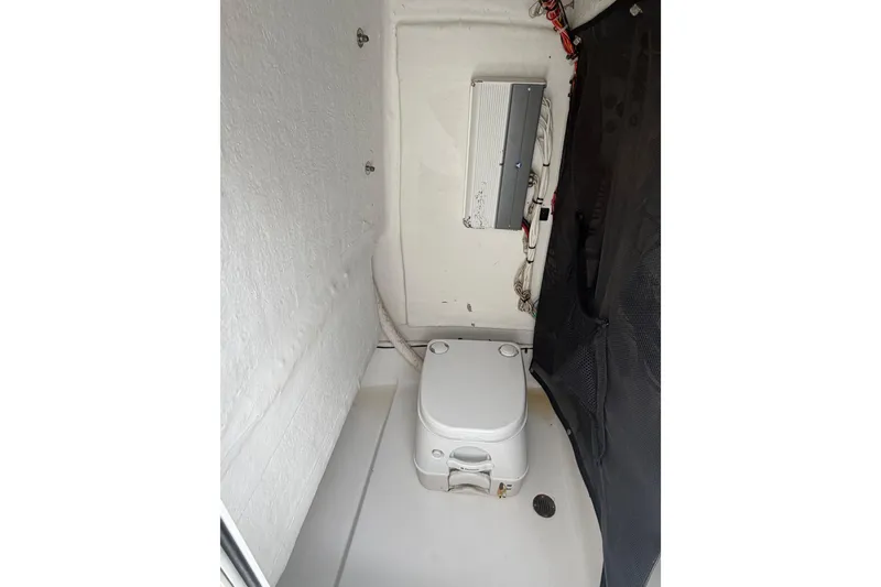 Slide: The Image of Interior of 2016 Sportsman Heritage 231 Center Console boat with compact toilet. - 16