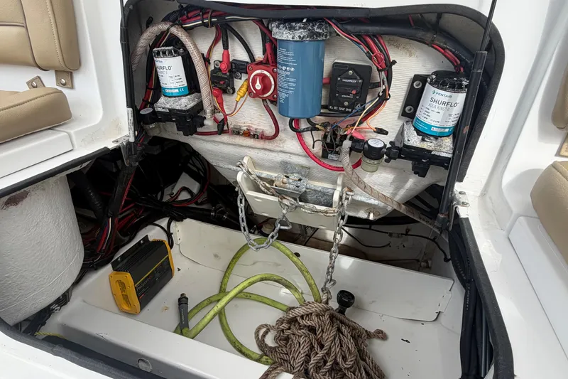 Slide: The Image of 2016 Sportsman Heritage 231 Center Console boat wiring and equipment compartment. - 17