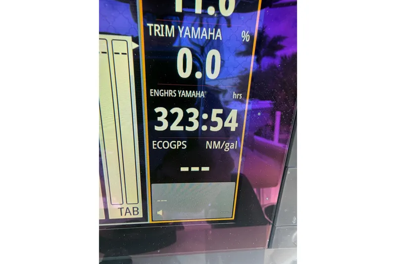 Slide: The Image of Display screen of 2016 Sportsman Heritage 231 Center Console showing engine hours and trim settings. - 18