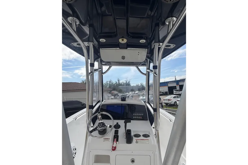 Slide: The Image of 2016 Sportsman Heritage 231 Center Console boat interior with steering wheel and control panel. - 5