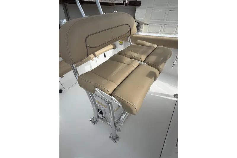 Slide: The Image of 2016 Sportsman Heritage 231 Center Console boat seat, tan upholstery, stainless steel frame. - 7