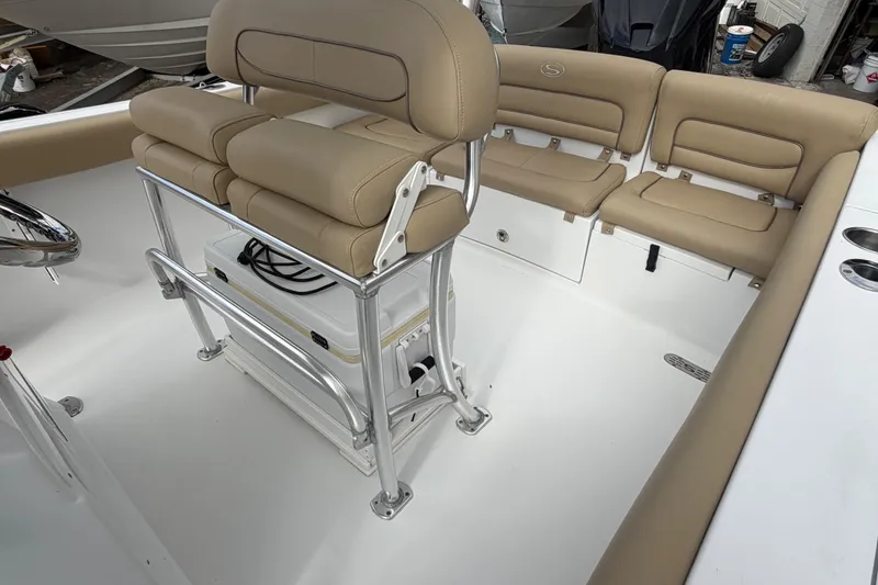 Slide: The Image of 2016 Sportsman Heritage 231 Center Console with tan seating and stainless steel fixtures. - 8