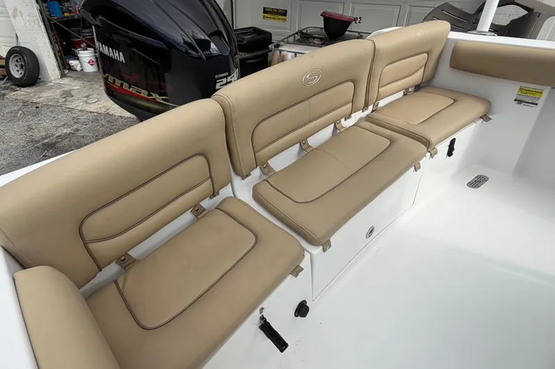 Slide: The Image of 2016 Sportsman Heritage 231 Center Console boat with tan seating and Yamaha engine. - 9