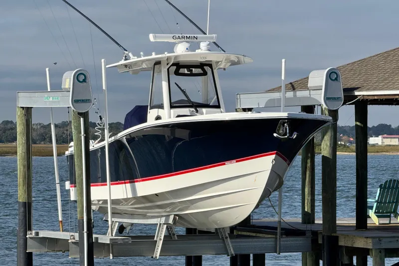 The Image of 2022 Regulator 34 boat on lift by waterfront dock. - 0