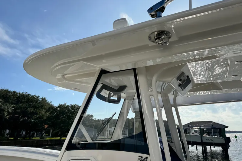 Slide: The Image of 2022 Regulator 34 boat dashboard with dual Garmin displays and control panel. - 20