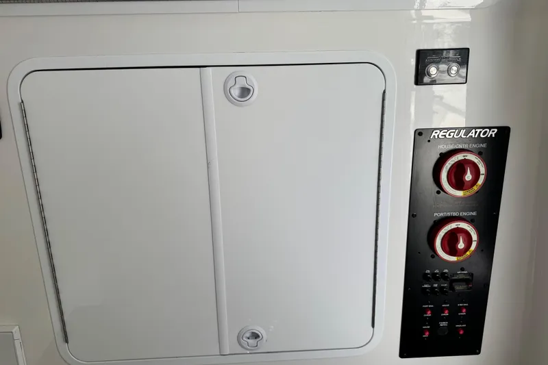 Slide: The Image of 2022 Regulator 34 boat interior with open storage compartments and sink. - 24