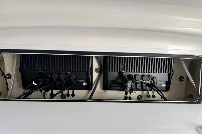 Slide: The Image of 2022 Regulator 34 boat with white cushioned helm seats and steering wheel. - 26