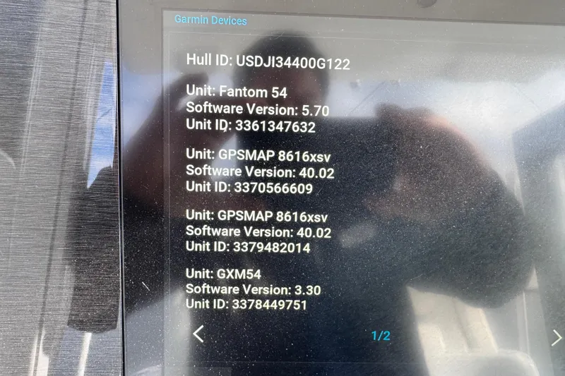 Slide: The Image of 2022 Regulator 34 boat storage compartments with open drawers and fishing line spools. - 27