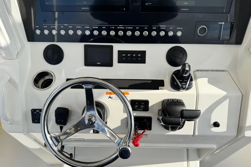 Slide: The Image of 2022 Regulator 34 boat storage compartment open, showcasing interior space. - 28