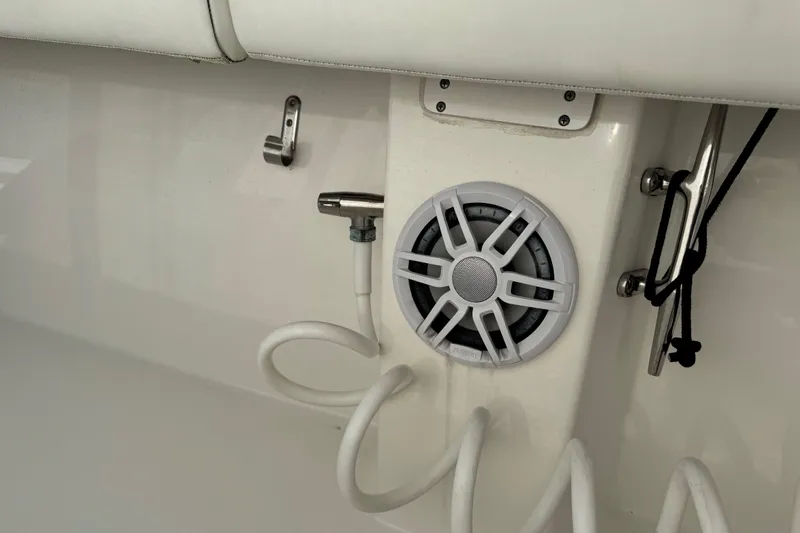 Slide: The Image of 2022 Regulator 34 boat interior with open storage compartment and cup holders. - 32