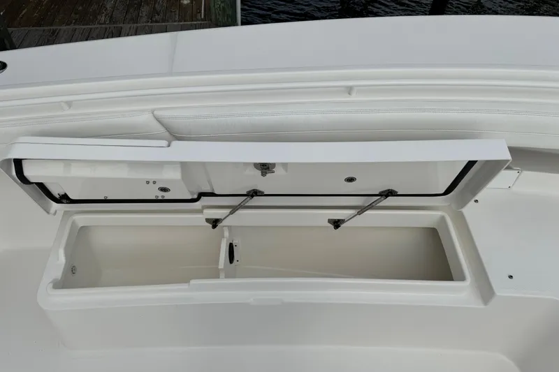Slide: The Image of 2022 Regulator 34 boat anchor compartment with open hatch and visible chain. - 37