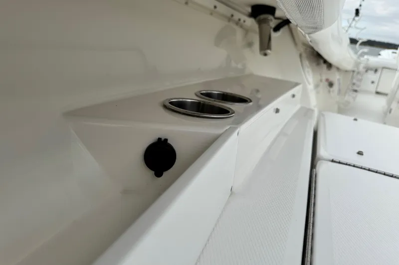 Slide: The Image of Close-up of a 2022 Regulator 34 boat's polished metal fitting against a cloudy sky. - 39