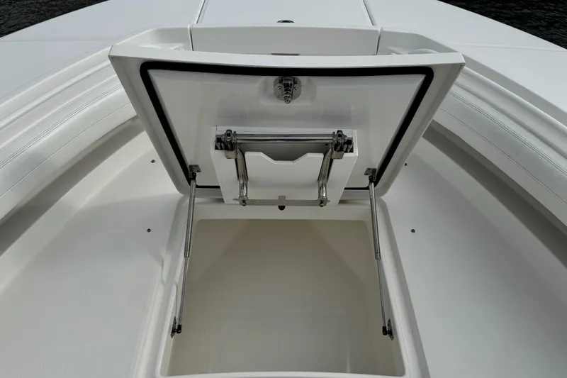 Slide: The Image of 2022 Regulator 34 boat with twin outboard engines, docked on calm water. - 40