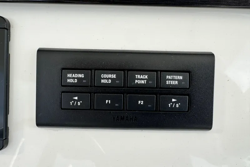 Slide: The Image of 2022 Regulator 34 boat interior with spacious seating and storage, docked by the water. - 43