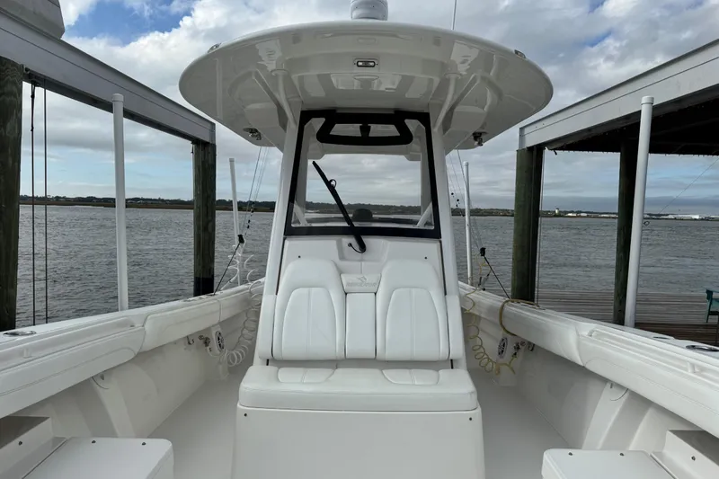 Slide: The Image of 2022 Regulator 34 boat storage compartment with teak deck and black hoses. - 45