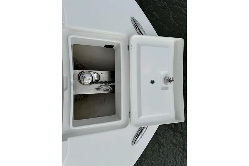 Slide: The Image of Livewell compartment on 2022 Regulator 34 boat, featuring a clean, white interior. - 46