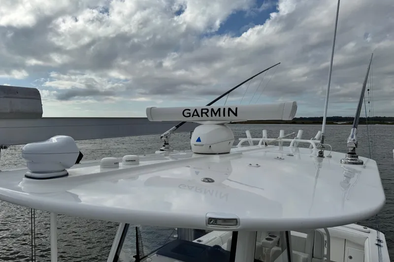 Slide: The Image of Storage compartment on 2022 Regulator 34 boat with pump controls and safety gear. - 47