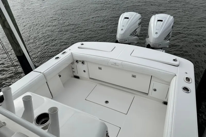 Slide: The Image of Storage compartment of 2022 Regulator 34 boat, featuring a black non-slip surface. - 49