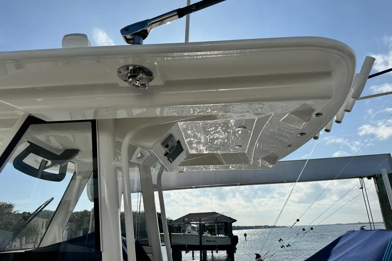 Slide: The Image of 2022 Regulator 34 boat, detailed view of the hardtop and fishing rod holders. - 6