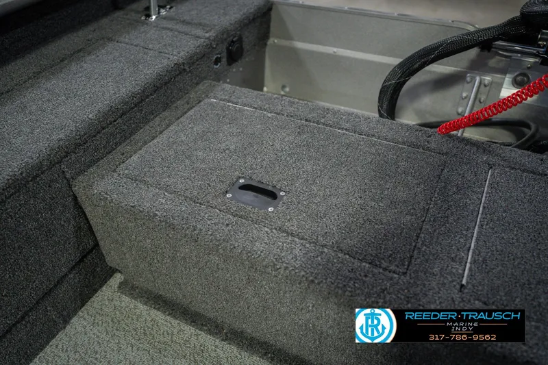 Slide: The Image of 2026 Lund 1875 Pro Guide boat interior with carpeted storage compartment. - 19