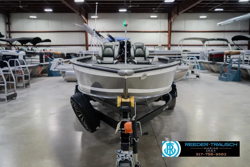 Slide: The Image of 2026 Lund 1875 Pro Guide boat in showroom, front view, displayed by Reeder Trausch Marine. - 2