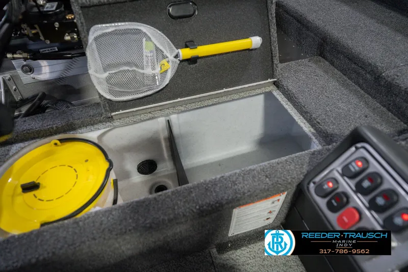 Slide: The Image of Interior of 2026 Lund 1875 Pro Guide boat with storage compartment and control panel. - 20