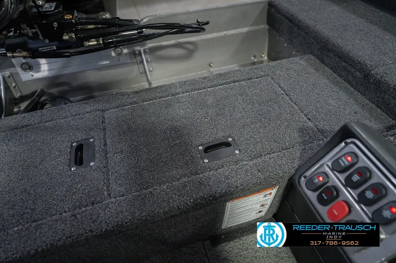 Slide: The Image of Interior of 2026 Lund 1875 Pro Guide boat with control panel and storage compartments. - 22