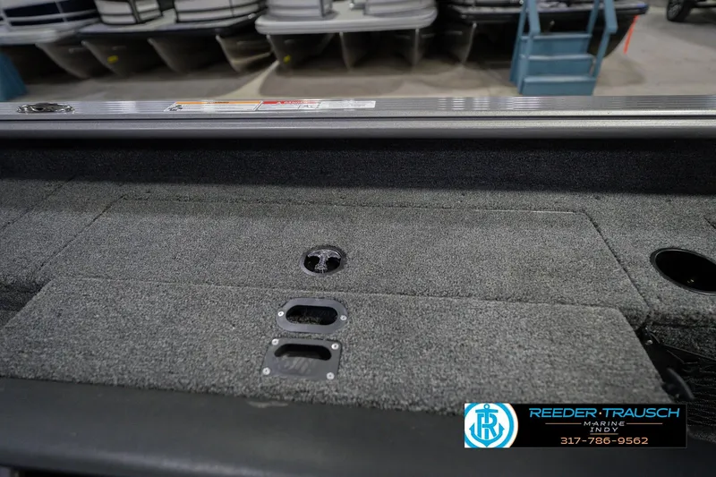 Slide: The Image of 2026 Lund 1875 Pro Guide boat interior with carpeted deck and storage compartments. - 23