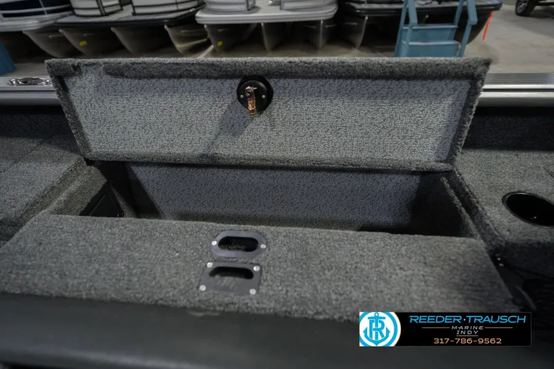 Slide: The Image of 2026 Lund 1875 Pro Guide boat storage compartment with carpeted interior. - 24