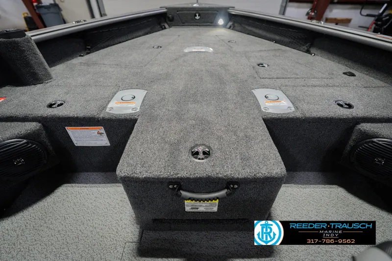 Slide: The Image of 2026 Lund 1875 Pro Guide boat interior with carpeted deck and storage compartments. - 26