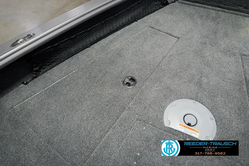 Slide: The Image of 2026 Lund 1875 Pro Guide boat interior with carpeted flooring and storage compartments. - 27