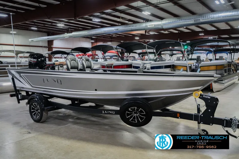 Slide: The Image of 2026 Lund 1875 Pro Guide boat in showroom, featuring sleek design and modern features. - 3