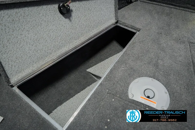Slide: The Image of 2026 Lund 1875 Pro Guide boat storage compartment with carpeted interior. - 31