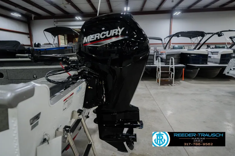 Slide: The Image of 2026 Lund 1875 Pro Guide boat with Mercury outboard motor in showroom. - 42