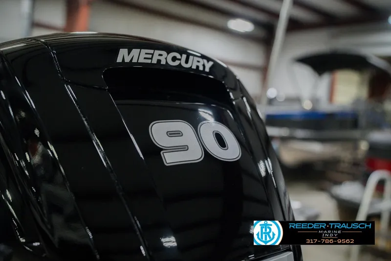 Slide: The Image of 2026 Lund 1875 Pro Guide with Mercury 90 engine in a showroom. - 43