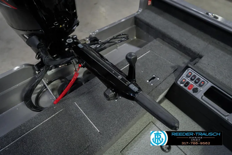 Slide: The Image of 2026 Lund 1875 Pro Guide boat interior with control panel and motor handle. - 46