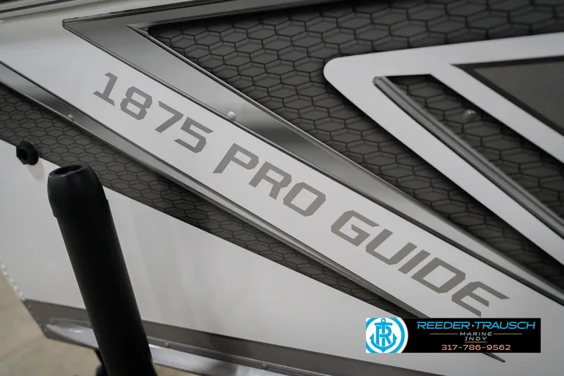 Slide: The Image of 2026 Lund 1875 Pro Guide boat branding with Reeder-Trausch Marine logo. - 48