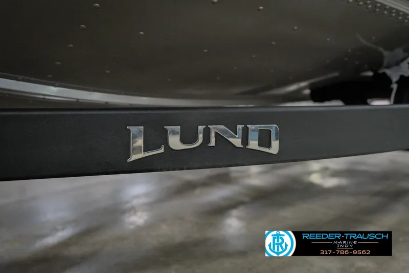 Slide: The Image of 2026 Lund 1875 Pro Guide boat logo on display at Reeder Trausch Marine. - 52