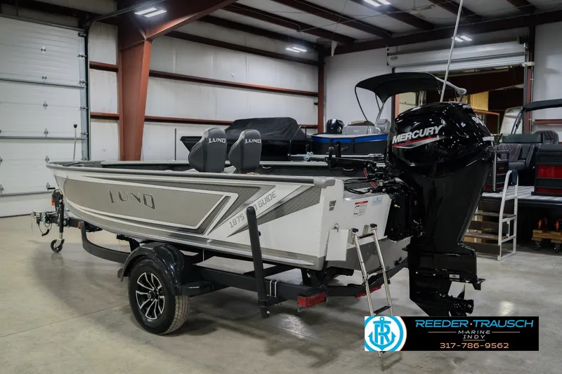 Slide: The Image of 2026 Lund 1875 Pro Guide boat with Mercury engine in showroom. - 6