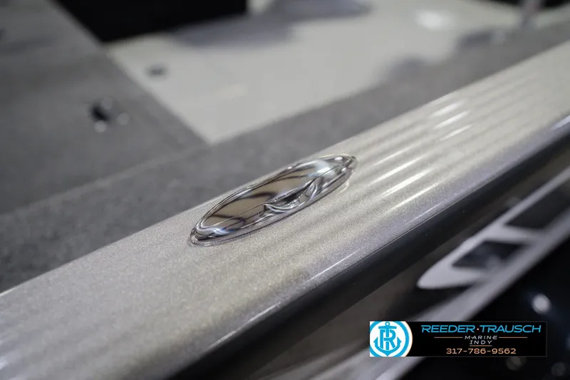 Slide: The Image of 2026 Lund 1875 Pro Guide boat detail with sleek metallic finish, Reeder Trausch Marine logo. - 63