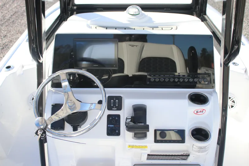 Slide: The Image of 2026 Tidewater 2110 Bay Max boat console with steering wheel and electronic controls. - 16