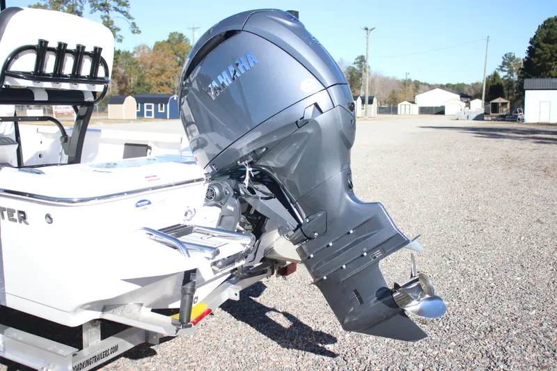 Slide: The Image of 2026 Tidewater 2110 Bay Max boat with Yamaha outboard motor in a gravel lot. - 25