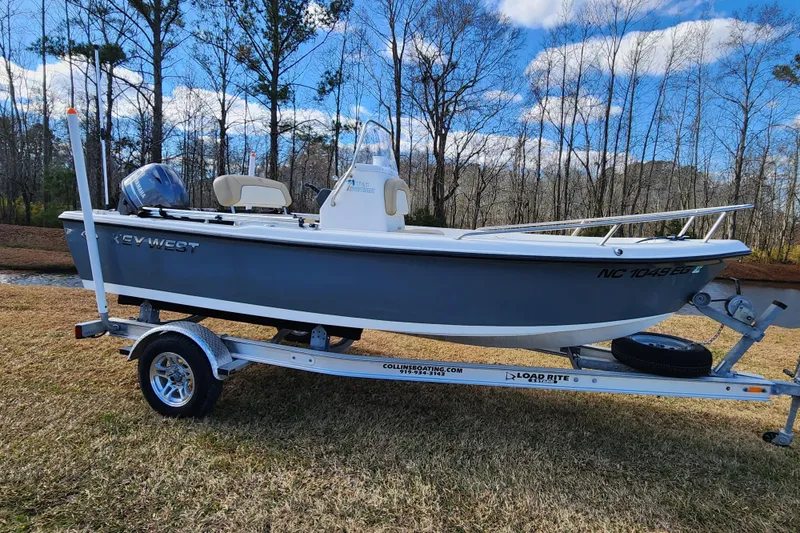 Slide: The Image of 2017 Key West 1720 Center Console boat on trailer, parked on grass. - 0